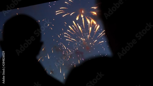 Silhouette people watching stand firework closeup background of night sky 4K.
