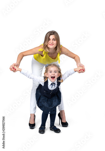 Happy smiling mom with little schoolgirl daughter, isolated on white background. 