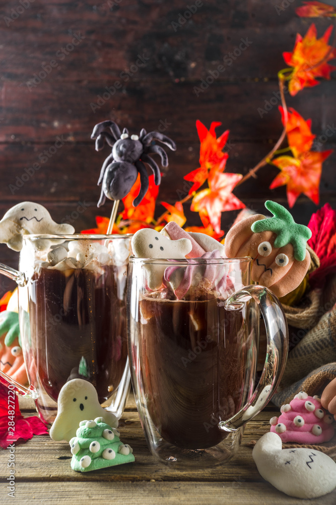 Halloween hot chocolate mugs with funny marshmallows - jack o lantern pumpkins, ghost, monsters, spiders.