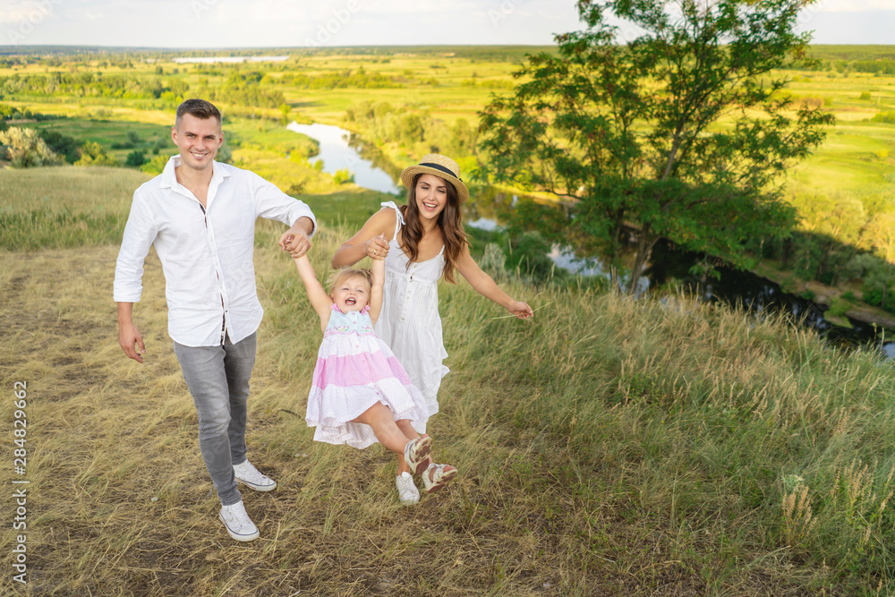 Parents are having fun with their little daughter. Family values Parents are having fun with their little daughter. Family values