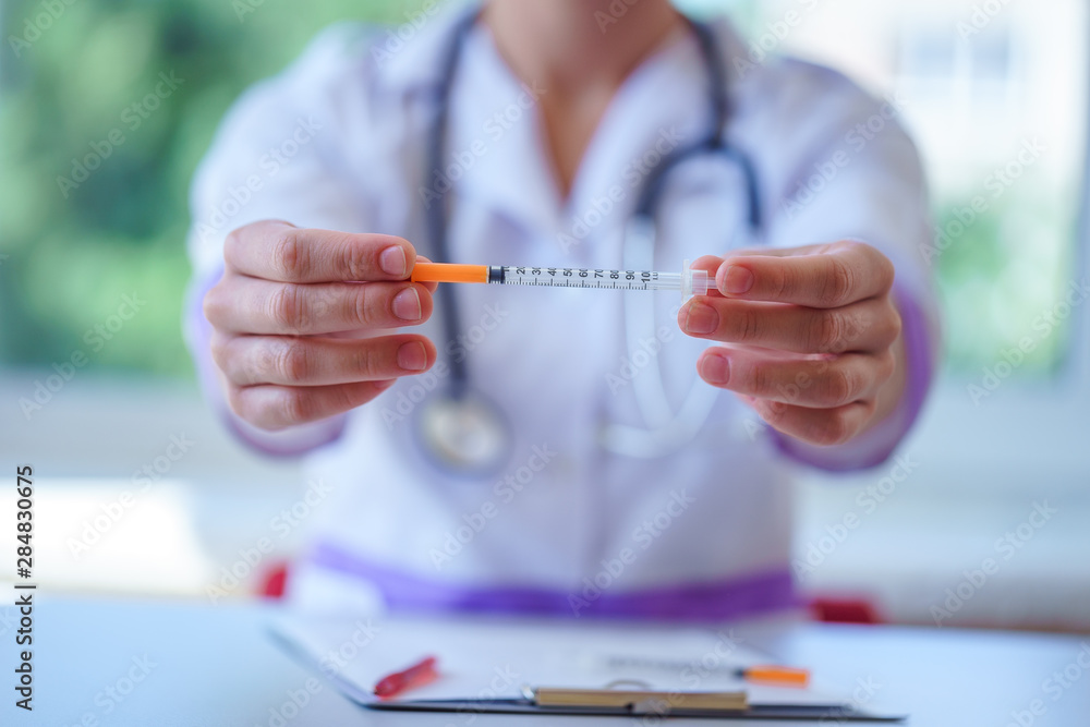 Doctor hold insulin injection syringe for diabetes patient during medical consultation and examination in hospital. Healthcare and endocrinology. Diabetic lifestyle Doctor hold insulin injection syringe for diabetes patient during medical consultation and examination in hospital. Healthcare and endocrinology. Diabetic lifestyle