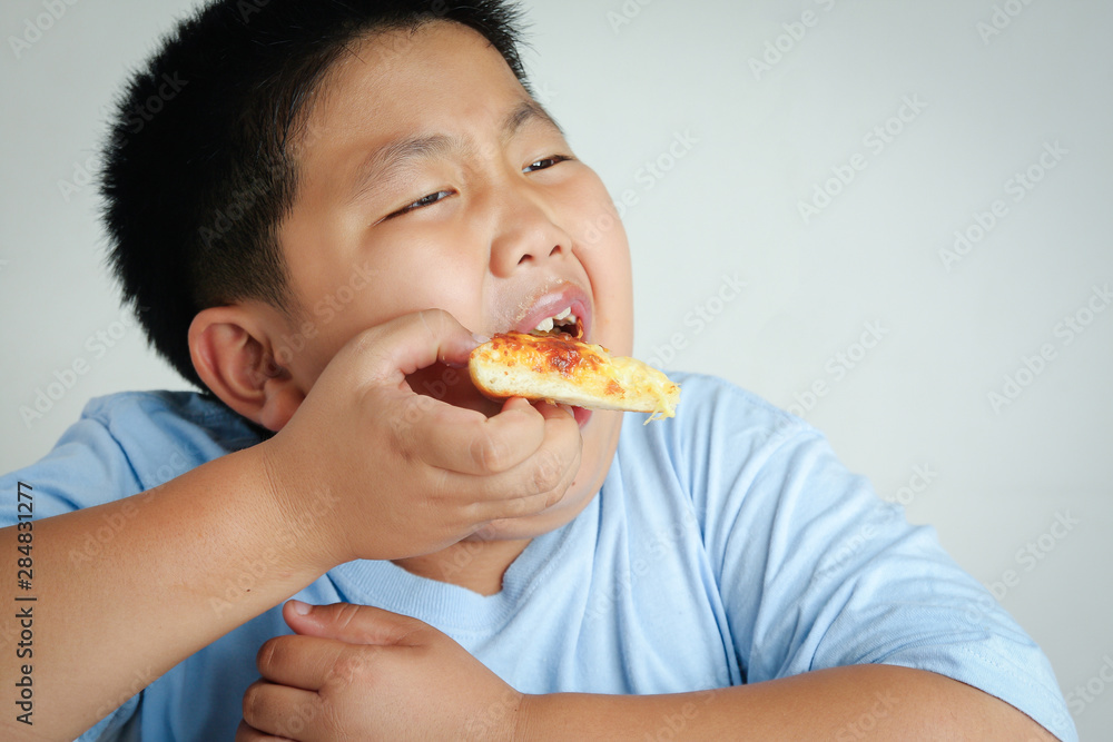 The fat boy is eating all the pizza. The fat boy is eating all the pizza.