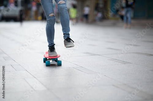 Skateboarder legs skateboarding at city
