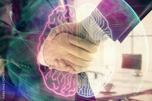 Double exposure of brain drawing on office background with two men handshake. Concept of innovation