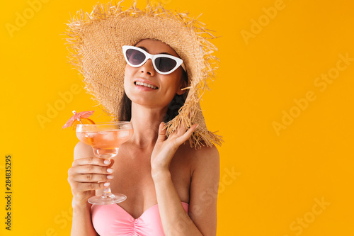 Attractive cheerful young girl wearing bikini standing