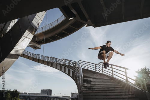 Parkour athlete training in the city. photo