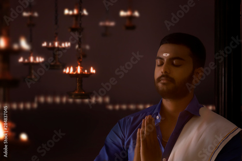 south indian man praying to god	 photo
