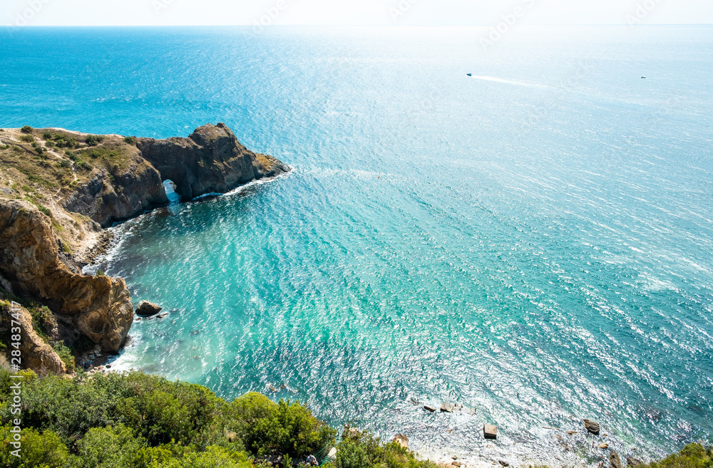 Summer sea landscape. Rocky coast of the Black sea in Crime Diana's grotto on Cape Fiolent, Sevastopol, Crimea, Russia.