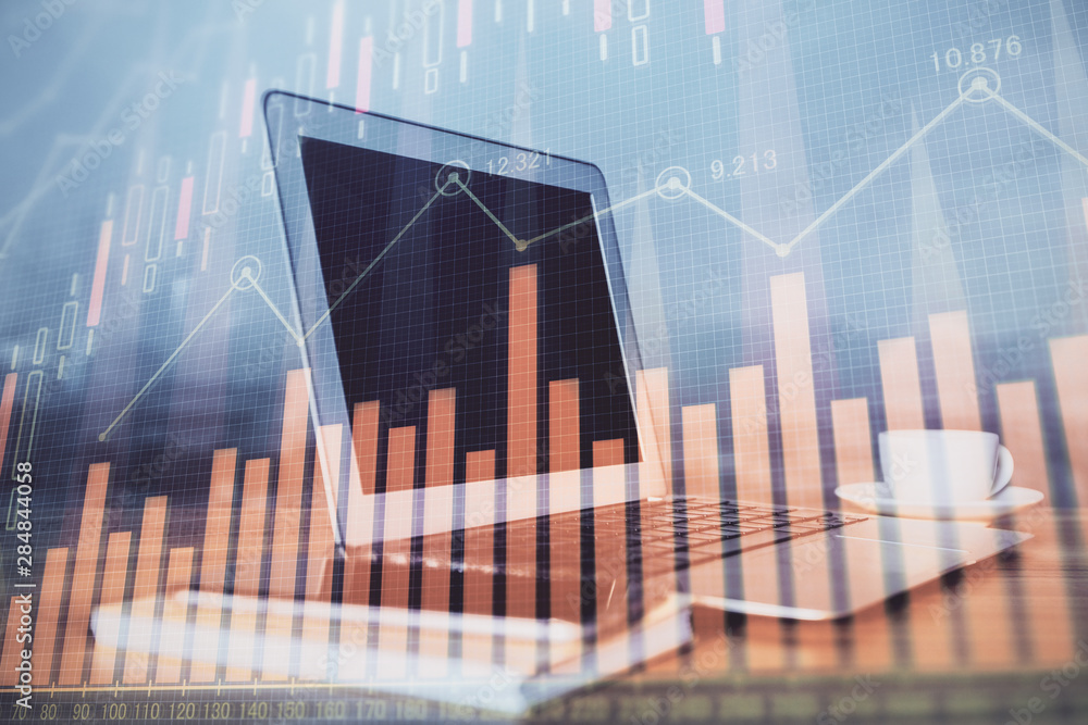 Financial market graph hologram and personal computer on background. Multi exposure. Concept of forex. Financial market graph hologram and personal computer on background. Multi exposure. Concept of forex.