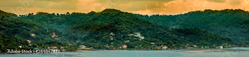 Panoramic view of Roatan, Honduras at sunrise, as seen from the sea.