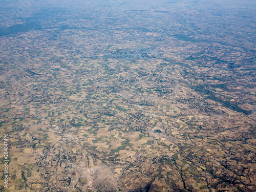 High aerial view of patchwork of farms and villages in Southern Ethiopia