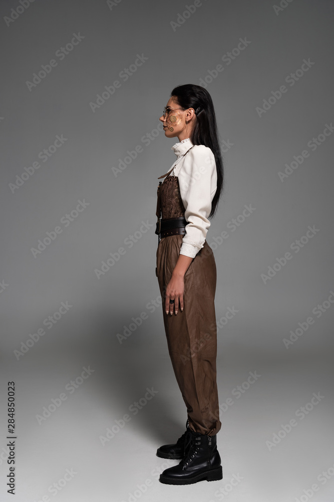 full length view of attractive steampunk woman in glasses on grey full length view of attractive steampunk woman in glasses on grey