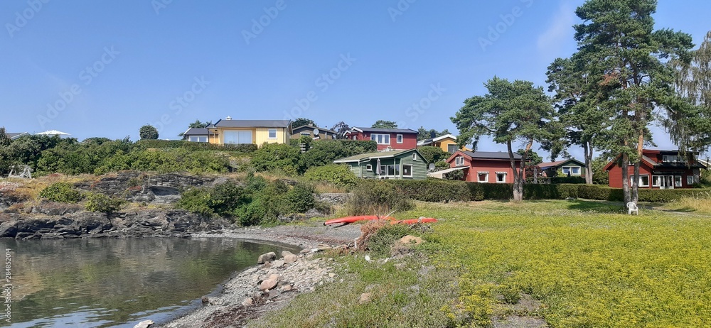 Island Lindoya in Oslo Fjord, Norway. Island with summer cottages and marina in summer. Island Lindoya in Oslo Fjord, Norway. Island with summer cottages and marina in summer.