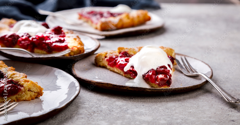 Bakery products. Summer pie with berries. Galeta with cherries sprinkled with powdered sugar. Bakery products. Summer pie with berries. Galeta with cherries sprinkled with powdered sugar.