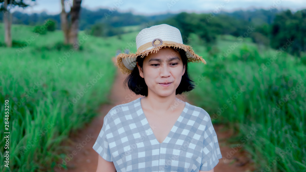 Portrait of beautiful women walking and smiling in the meadow at Khao yai national park Thailand
