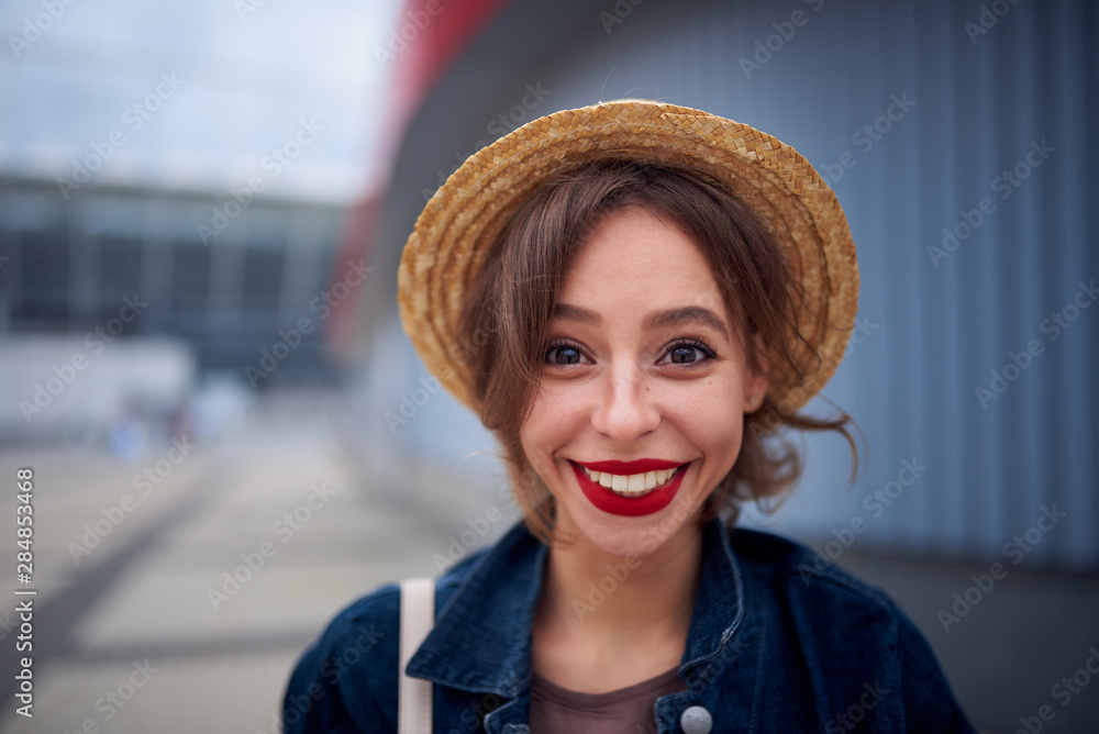 Beautiful woman in a hat smiles and enjoy life