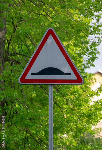 Road sign on city background