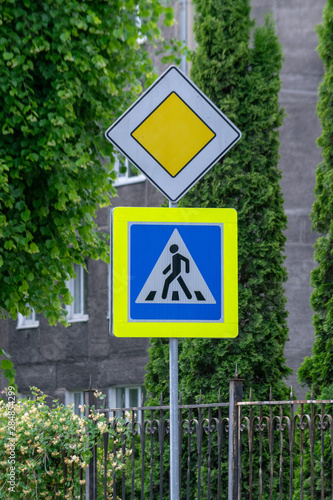 Road sign on city background