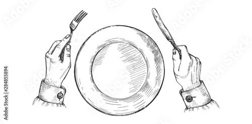 Hands holds silver fork and knife
