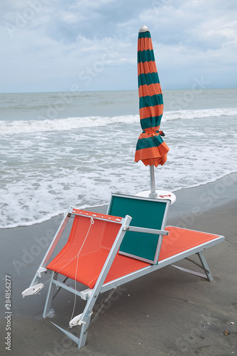 Milano Marittima, Italy -  July 28, 2019 : Sunbed and parasol by the sea