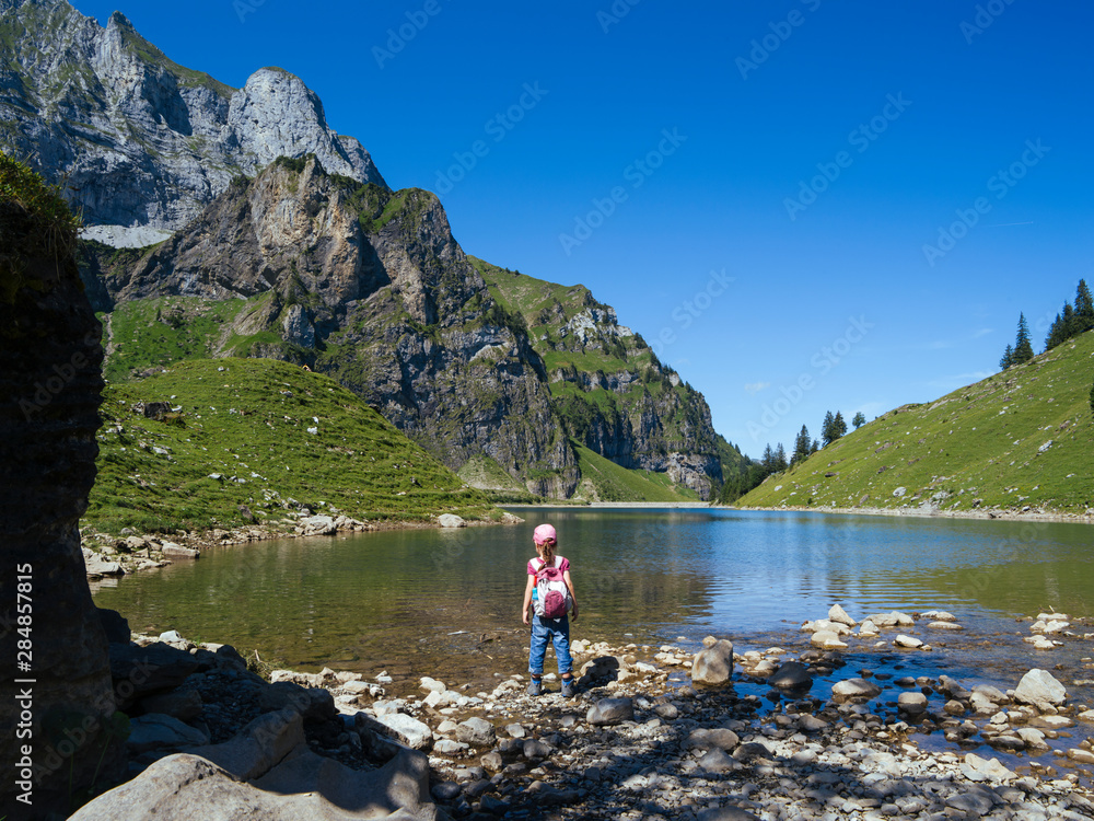 Young girl hiking around Bannalpsee in Switzerland