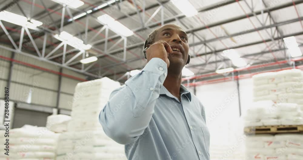 Close up of a male warehouse worker using headset in a storeroom 4k Close up of a male warehouse worker using headset in a storeroom 4k