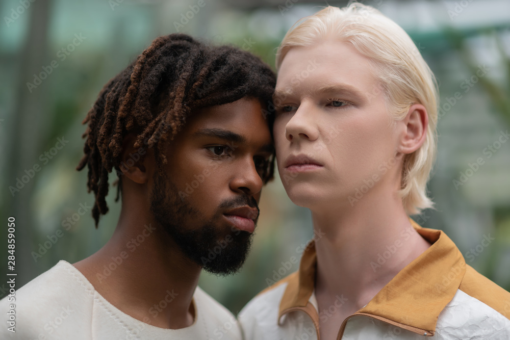 Men with different skin color feeling serious and confident Men with different skin color feeling serious and confident