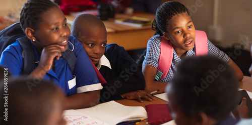 Schoolchildren talking during a break at a township school