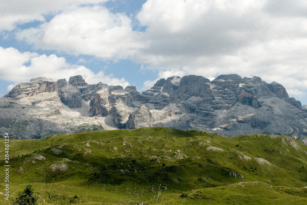 mountains of Cima Tosa, Cima Brenta Peak and Grosté Pass, meadow, Dolomites, Madonna di Campiglio, summer, sport, trekking, hiking, travel, sun, clouds, Alps, Trentino Alto Adige, Italy