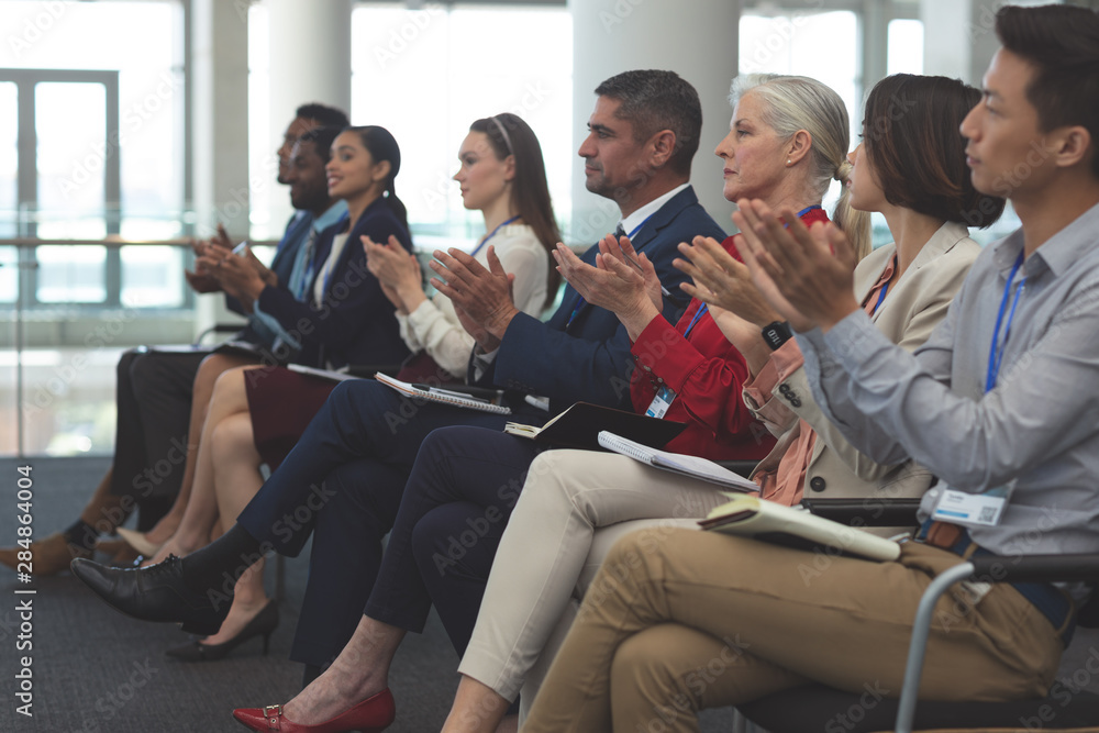 Business people applauding in a business seminar Business people applauding in a business seminar