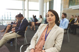 Young businesswoman looking at camera during seminar 
