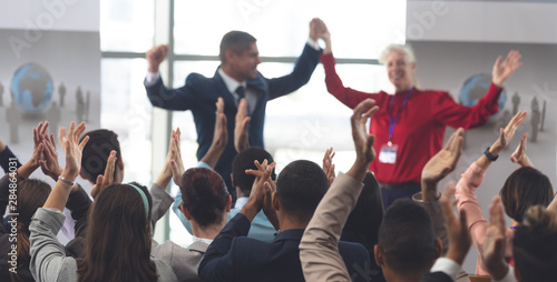 Business people applauding and celebrating in a business seminar