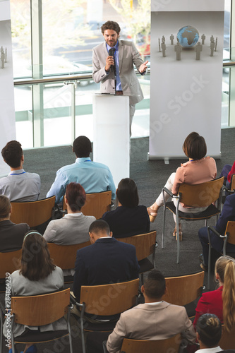 Male speaker with microphone speaks in a business seminar