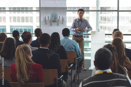 Young male Asian businessman speaks at a business seminar