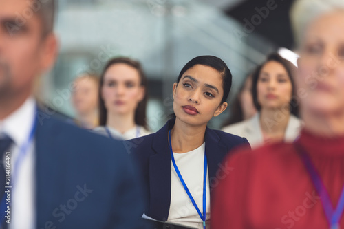 Fotografiet Attractive young businesswoman in a business seminar