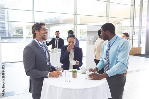 Fotografie Business people interacting with each other at table during a seminar