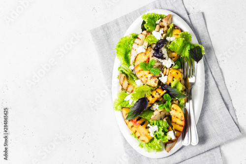 Grilled stone fruit feta cheese salad with basil and peanuts. Top view, copy space.