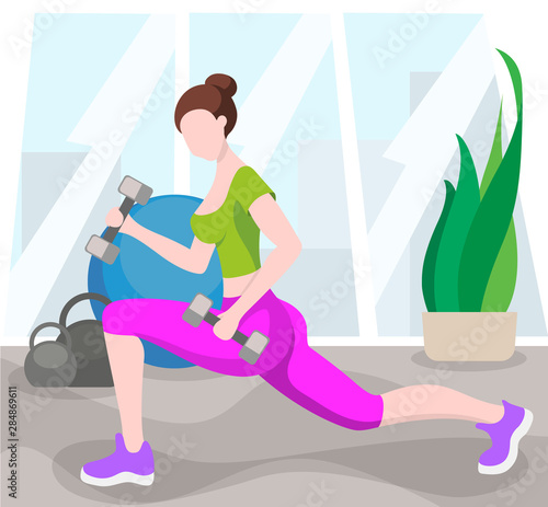 Girl is training in the fitness room