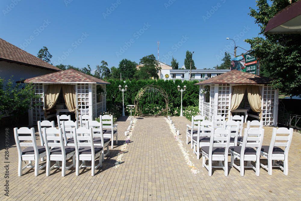 Stylish wedding  arc of the vine with flowers and candels . Beautiful place of  wedding ceremony outdoors. stylish place of wedding celebration.wedding background.