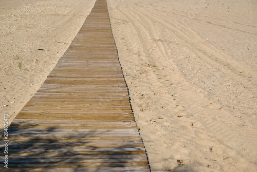 wooden path on the sand on a beach