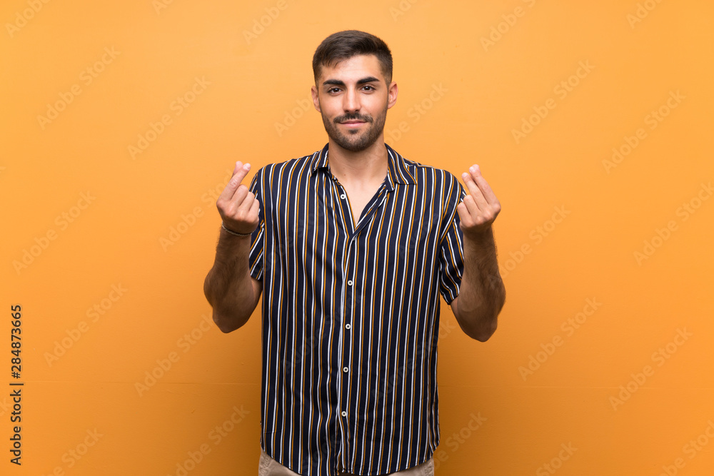 Handsome man with beard over isolated background making money gesture Handsome man with beard over isolated background making money gesture