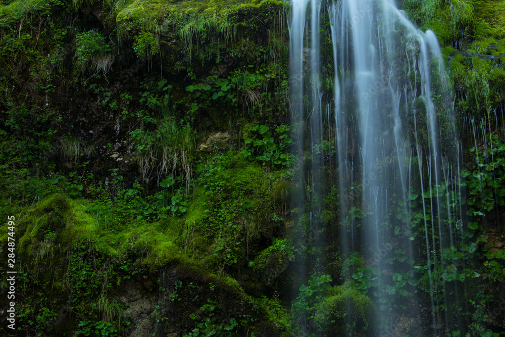 Water flowing over rock full of moss Water flowing over rock full of moss