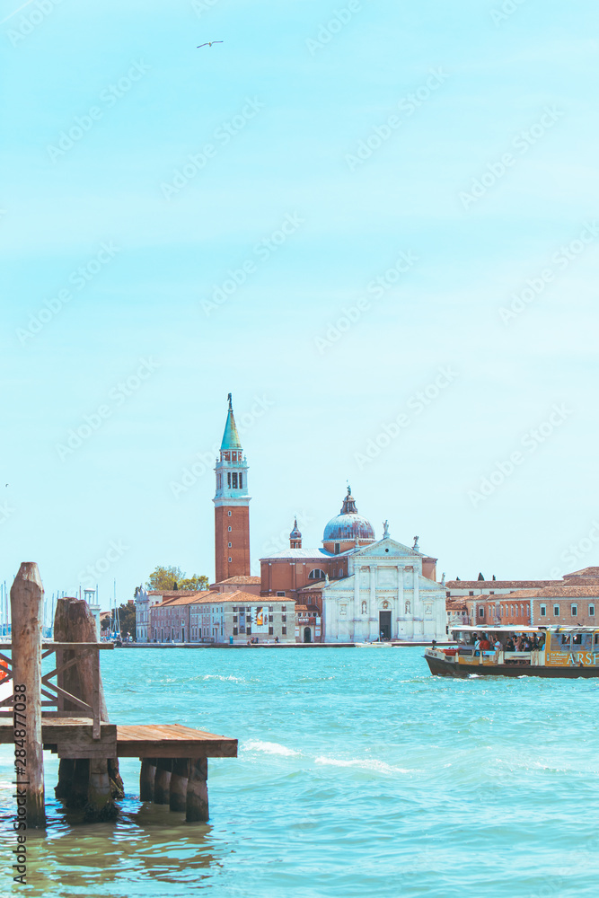 Fototapeta premium view of Church of San Giorgio Maggiore boats before it famous landmark place
