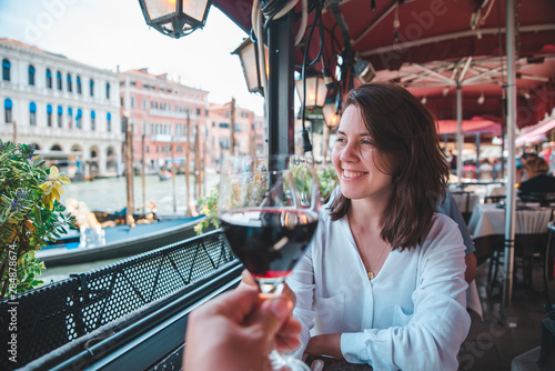 first person point of view couple in cafe outdoors drinking wine smiling woman