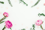 Floral composition with pink flowers and eucalyptus on white background. Flat lay, top view