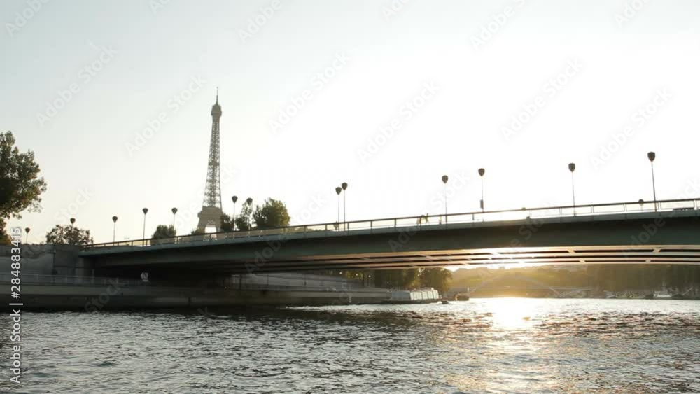 Paris, France: Sailing on the river Seine in Paris at sunset under the bridge Paris, France: Sailing on the river Seine in Paris at sunset under the bridge