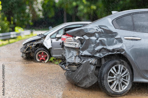 Raining day front of light gray color car crash with back side of  gray color car 2 car have damaged and broken by accident on road parking can not dirve any more. © AKGK Studio