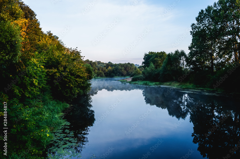 Fog over the river bed. Dawn on the river in summer. Fog over the river bed. Dawn on the river in summer.