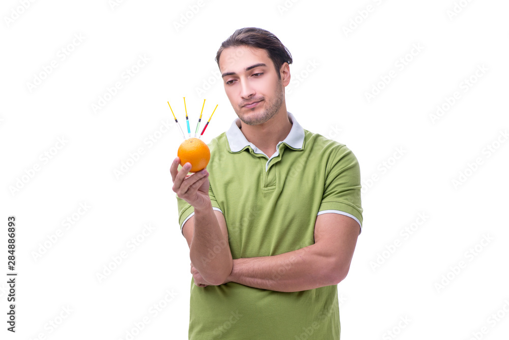 Young man in GMO fruits and vegetables concept Young man in GMO fruits and vegetables concept