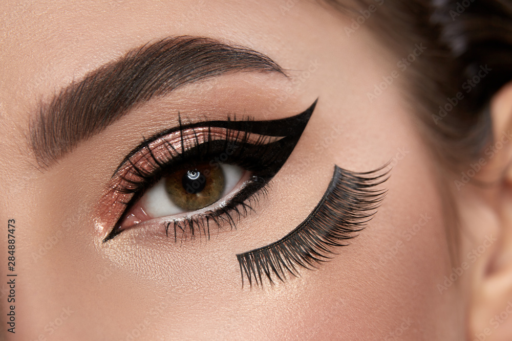 fashion make-up closeup with eyeliner and false eyelashes under eye
